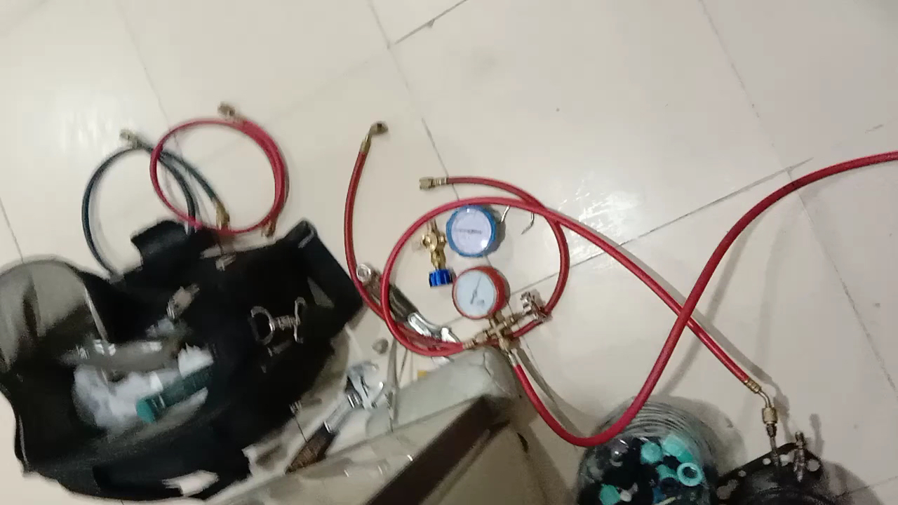 AC gas charging gauges and hoses on a Cool Planet job