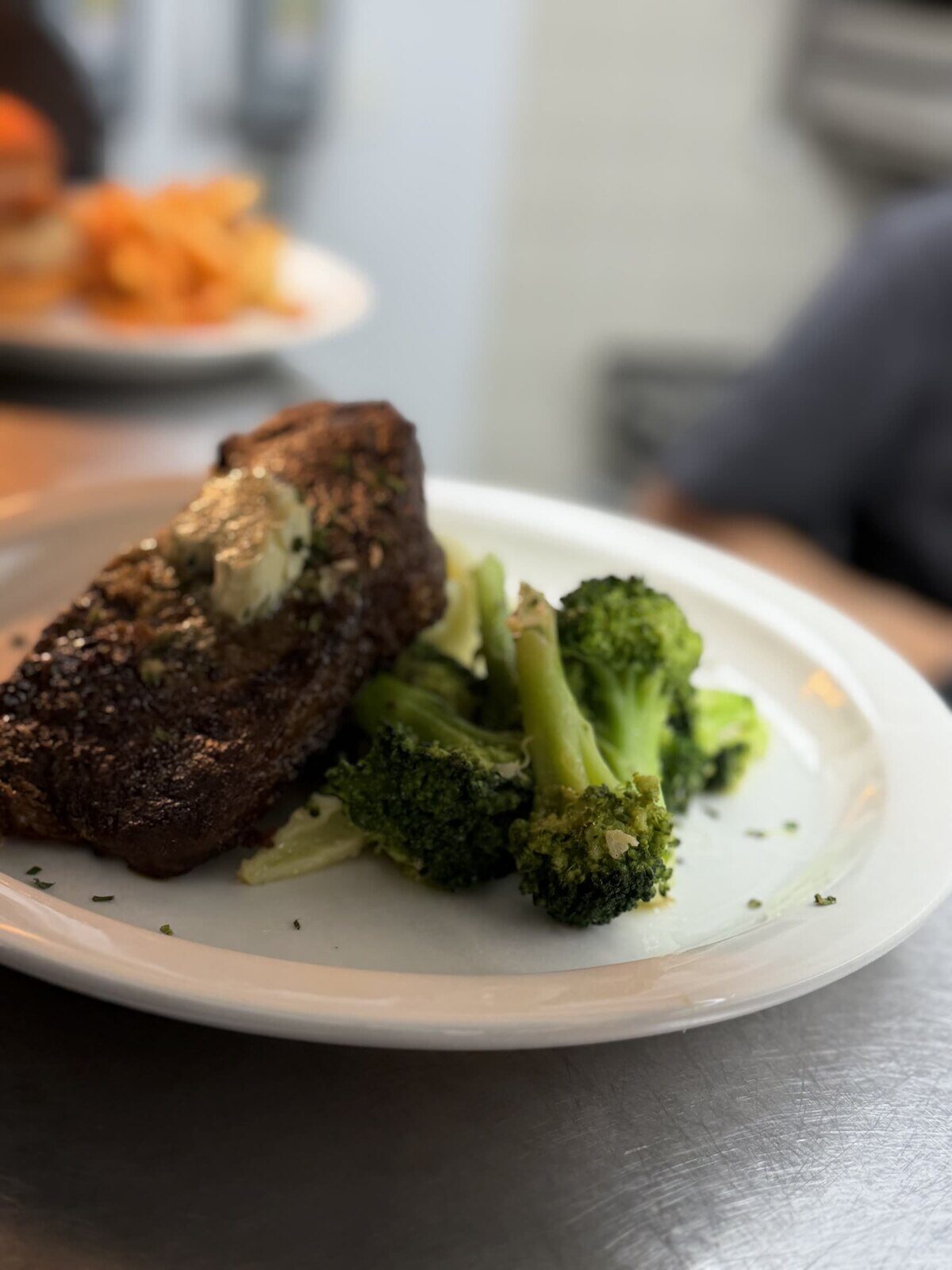 New York strip steak with herb butter and broccoli